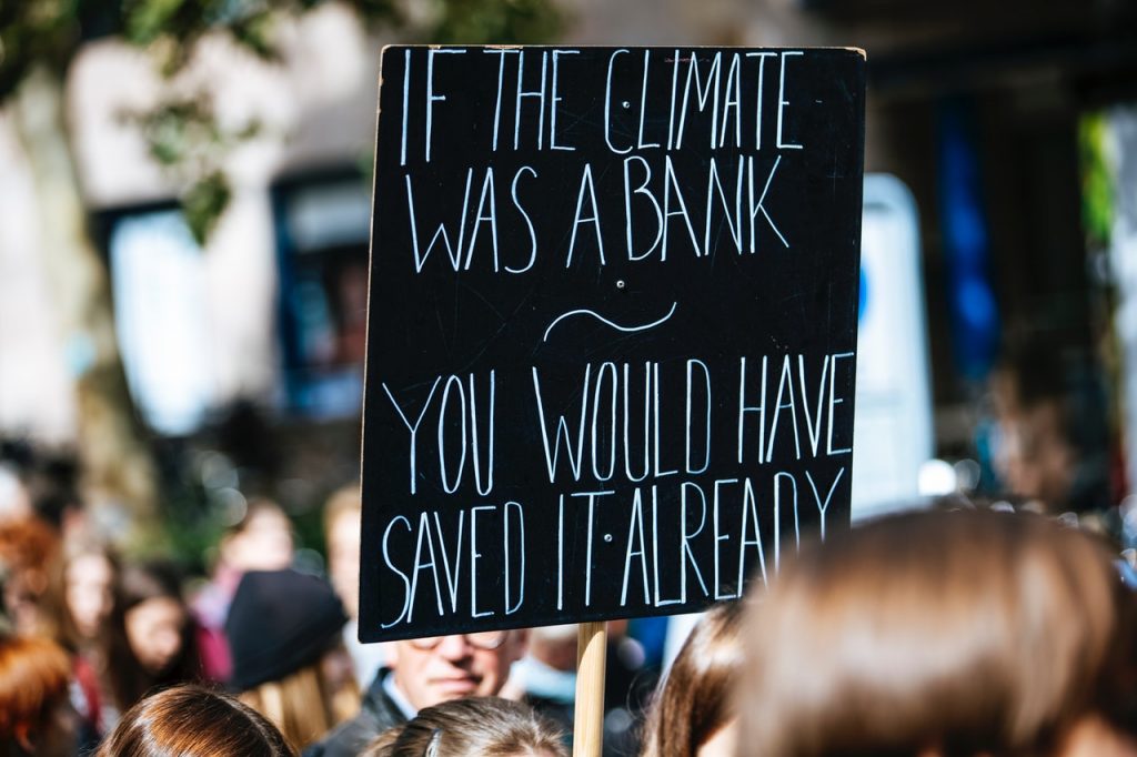 A sign reading "If the climate was a bank you would have saved it already."